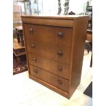 A mid century teak chest fitted with one cushion drawer over four long drawers raised on a plinth