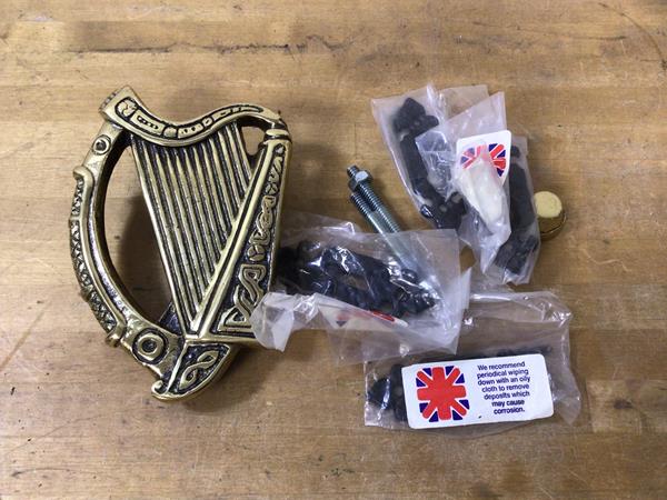 A brass Celtic harp style door knocker, (14cm x 10cm)