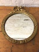 A Georgian inspired wall mirror with the circular glass within gilt frame with ribbon surmount (41cm