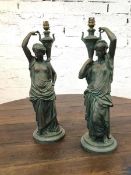 A pair of cast metal table lamps in the form of female water carriers, (55cm h)