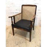 A first half 20thc mahogany library chair with caned back and sides, arms on turned supports, drop