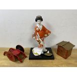 A Japanese Hakata doll with label to base,