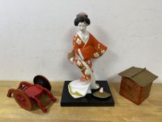 A Japanese Hakata doll with label to base,