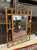 A cane wall mirror with rectangular glass, measures 107cm high x 75cm