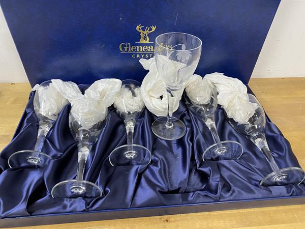 A set of six Gleneagles crystal wine glasses with etched floral decoration,