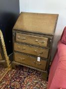 An Edwardian mahogany bureau of small proportions, fall front enclosing a fitted interior above