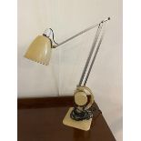 A latter half of 20thc adjustable desk lamp with conical shade on polished metal supports, painted