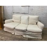 A two seater sofa circa 1930's / 40's with later fitted natural cotton cover, feather filled squab