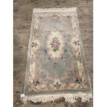 A Chinese rug, the central medallion with C scrolls and floral decoration within matching border, (