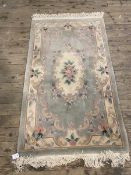 A Chinese rug, the central medallion with C scrolls and floral decoration within matching border, (