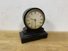 An Edwardian mantel clock, the ebonised wooden frame with circular dial and roman numerals, movement