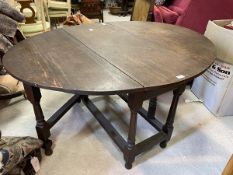 A George III oak drop-leaf dining table, the drop leaf sides form oval surface when open,