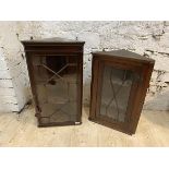 Two 19thc mahogany hanging corner cabinets, both with glazed doors and shelves to interior, larger