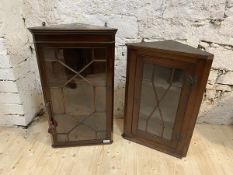 Two 19thc mahogany hanging corner cabinets, both with glazed doors and shelves to interior, larger