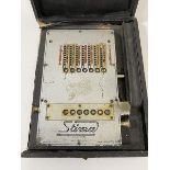 A vintage Stima mechanical calculator in original box, measures 16cm x 13cm