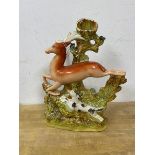 A 19thc Staffordshire pottery flatback spill vase figure of a dog chasing a hind, (29cm high)
