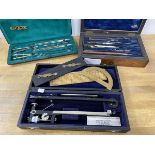 A collection of scientific / geometric equipment including dividers, a slide rule, a set of