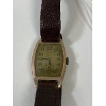 A 1920's gentlemans wrist watch, on leather strap, case marked 375, measures 4cm x 2.5cm