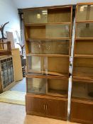 A Minty oak sectional bookcase with five tiers, having sliding glass doors, on base