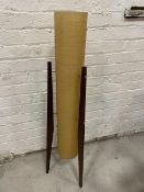 A rocket lamp with spun fibre glass shade on teak supports,