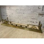 A classical style brass fender with four acorn finial's on tapering fluted column supports and