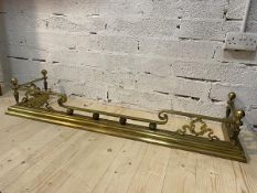 A classical style brass fender with four acorn finial's on tapering fluted column supports and