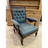 A late 19th early 20thc mahogany campaign open arm chair with buttoned back, upholstered cushioned