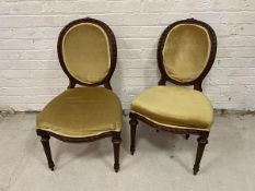 A pair of balloon back Victorian walnut side chairs with upholstered backs and seats on turned