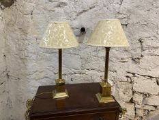 A pair of brass table lamps with column supports having corinthian style capitals, on pediment