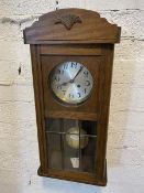 A Vienna regulator style wall clock in oak case, crest rail with paw mat over circular dial with