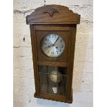 A Vienna regulator style wall clock in oak case, crest rail with paw mat over circular dial with