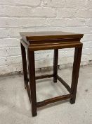 A Chinese hardwood occasional table, the square top with recessed frieze, on straight supports