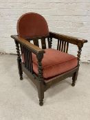 A 1920's / 30's easy chair with reclining seat, the domed headrest above beaded frieze and three