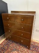 A Georgian inspired chest of drawers with ledge back over rectangular top having bead and ribbon