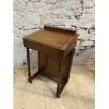 A 19thc mahogany Davenport the hinged superstructure with pen tray and recesses over slant hinged