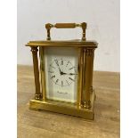 A Richard and Cie carriage style mantel clock with fixed handle over a dial with roman numerals with