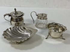 A quantity of silver including three condiment pots, one with glass base and silver collar and