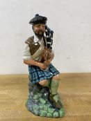 A Royal Doulton figure, The Piper, dated 1979 to base, modelled by Michael Abberley,