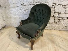 A Victorian walnut nursing chair with buttoned back and arms over sprawled and carved arms and