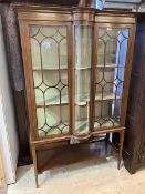 An Edwardian mahogany display cabinet the moulded top over inlaid frieze with central convex section