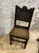 An early 19thc oak side chair with carved top rail and panel back on turned front supports united by