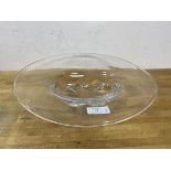 An Swedish Orrefors glass bowl with large flattened rim over tablet shaped well,