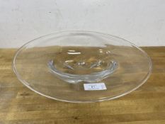An Swedish Orrefors glass bowl with large flattened rim over tablet shaped well,
