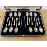 A boxed set of twelve silver coffee spoons with sugar nips, Sheffield 1930, in original box,