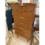 A mid century teak tall chest of six drawers on turned supports, (127cm x 61cm x 44cm)