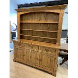 A modern pine dresser, the plate rack with three shelves within plaster supports and moulded