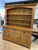 A modern pine dresser, the plate rack with three shelves within plaster supports and moulded