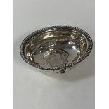 A white metal dish with beaded edge and George II shilling to base, measures 2.5cm x 7.5cm x 5.