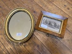 An Edwardian oval mirror with gadrooned and beaded gilt frame, some losses, (30cm x 24cm), and a