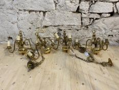 A set of four Dutch style brass chandeliers with scrolled arms, faux candles, chain and ceiling